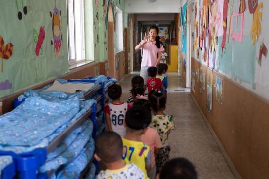 彭晓雯带着孩子们排队走向教室（9月7日摄）。
